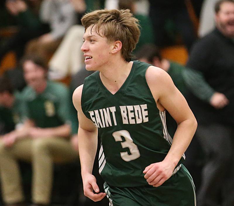 St. Bede's Callan Hueneburg reacts after sinking a three point basket over Marquette in the Class 1A Regional semifinal on Wednesday, Feb. 22, 2023 at Midland High School.