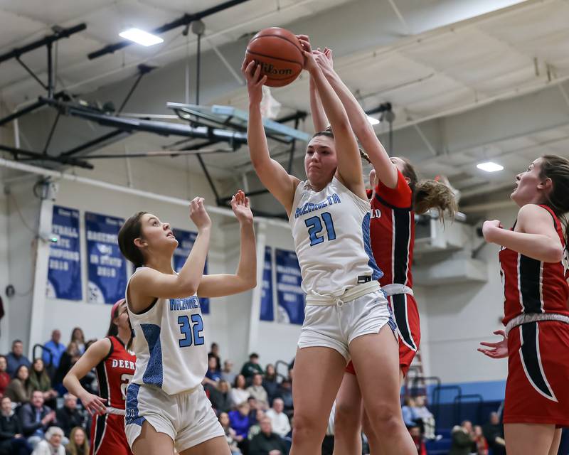 Nazareth's Olivia Austin (21) grabs a rebound during varsity basketball game between Deerfield at Nazareth.  Jan 23, 2023.