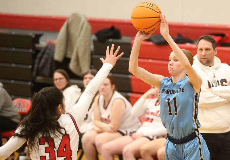 Marquette's Keely Nelson taks a jump shot over Hall's Natalia Zamora on Thursday, Feb. 13, 2025 at Hall High School.