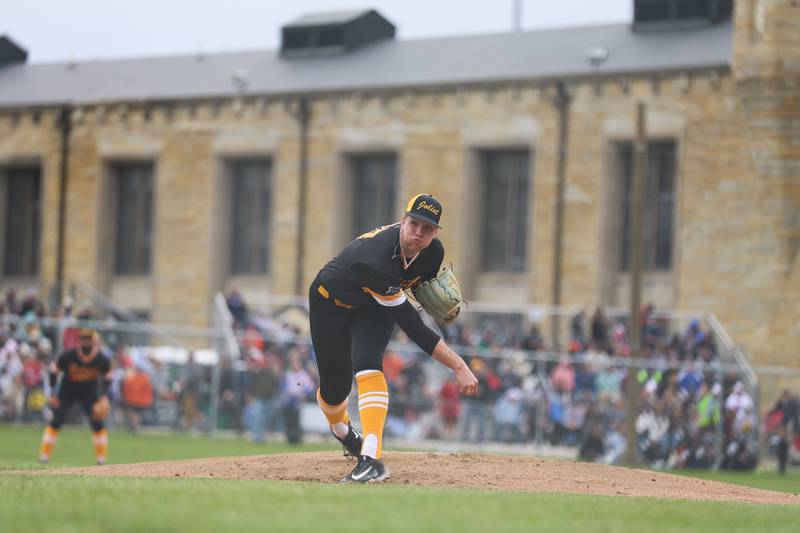 The old prison sets as a backdrop as a Joliet Slammers pitcher delivers a pitch against the Gate Way Grizzlies during the Joliet Slammers preseason game at the Old Joliet Prison on Thursday, April 29, 2026 in Joliet.