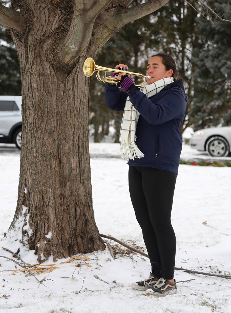 Clara Paulson plays taps at St. Gall’s Cemetery in Elburn on Saturday, Dec. 17, 2022.