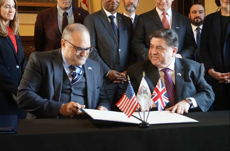 U.K. Consul General Richard Hyde, left, and Illinois Gov. JB Pritzker sign a memorandum of understanding regarding trade during a ceremony in the governor’s Statehouse on Tuesday, April 8, 2025