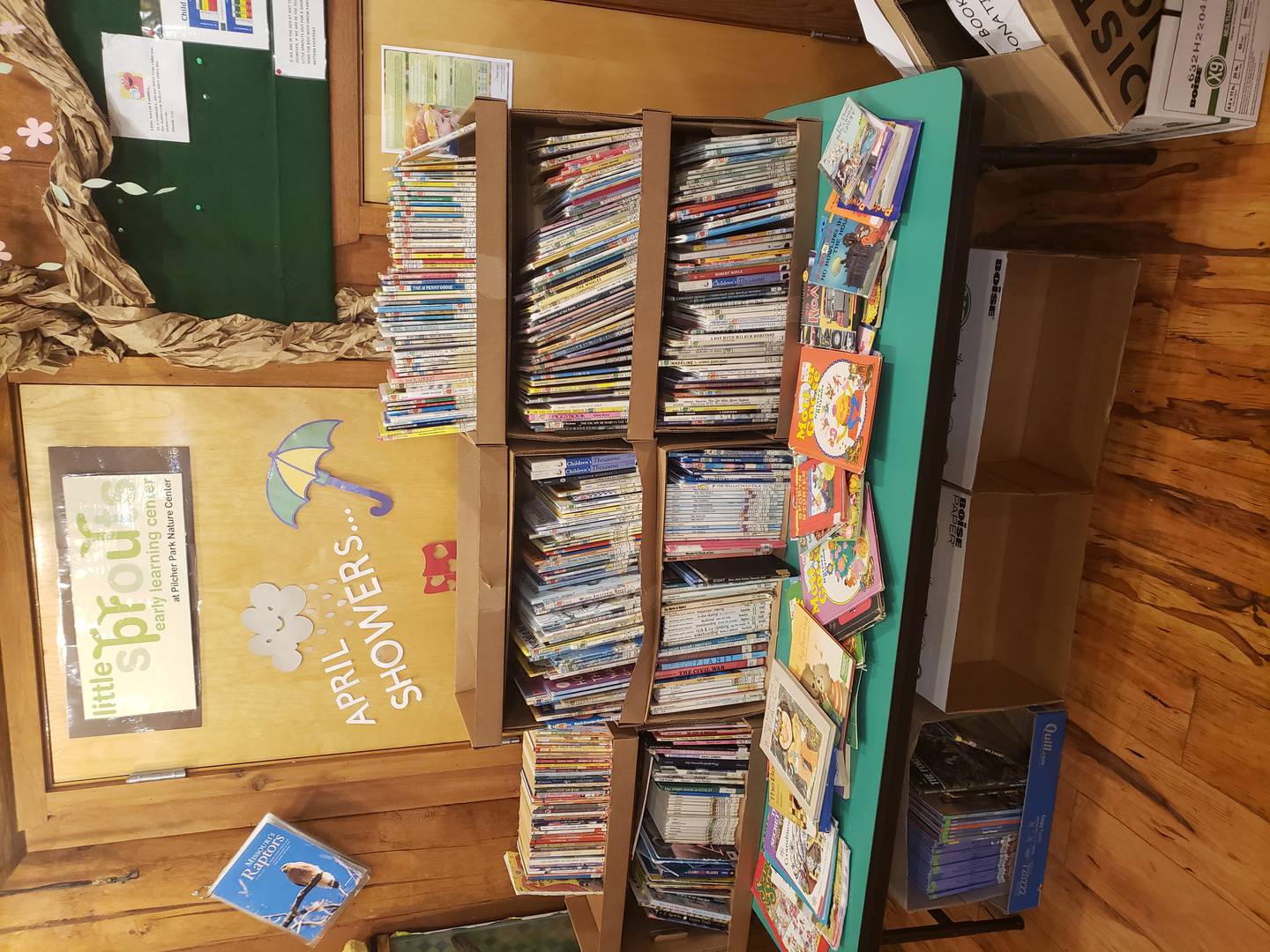 A table of children's books at the Pilcher Park Nature Center in Joliet at the 2024 Book Reuse and Recycling Event.