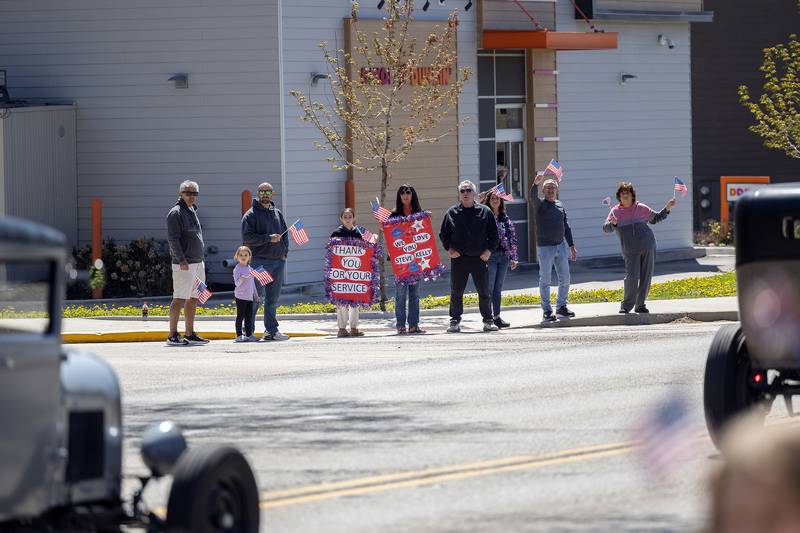 Celebrants wave flags and show off signs of support Saturday, April, 26, 2025, in Dixon. Dixon VFW Post 540 held a Vietnam veteran parade down Galena Avenue to recognize those veterans who didn’t receive the thank you they deserved.