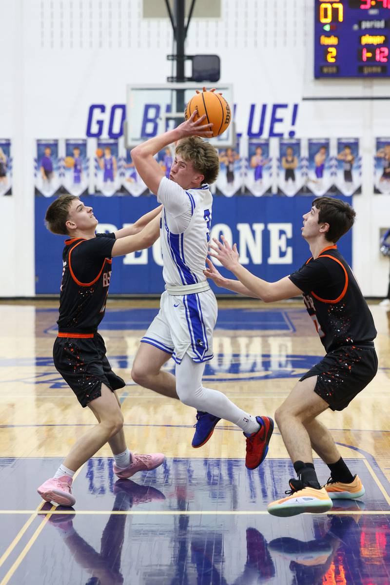 Peotone's Nick Cronin maneuvers to the basket under pressure from Beecher players during the Blue Devils' 64-52 victory over Beecher on Wednesday, Jan. 28, 2026.