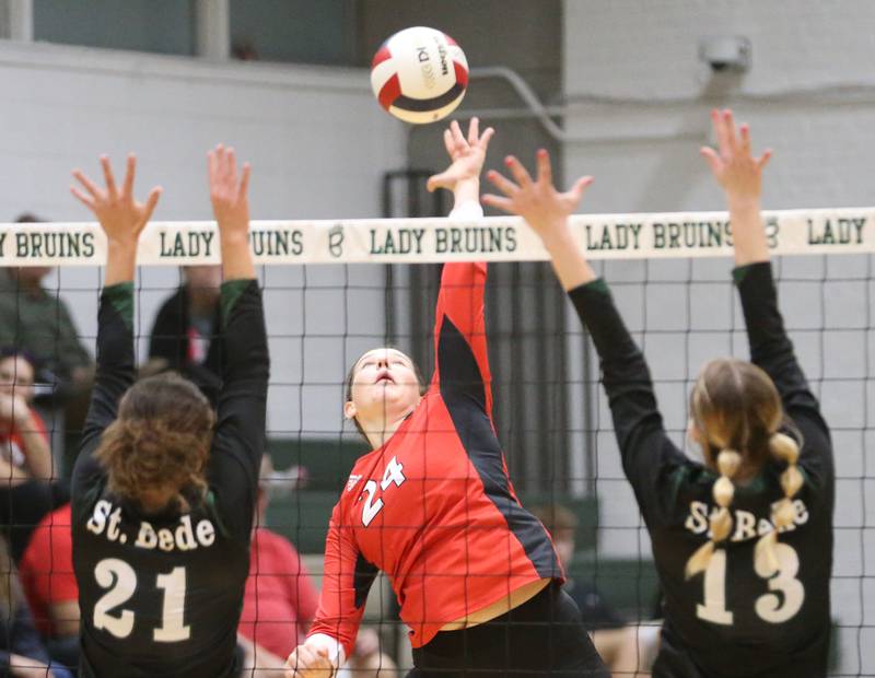 Henry-Senachwine's Harper Schrock sends a kill past St. Bede's Lily Bosnich and teammate Ashlyn Ehm during the Class 1A Regional final game on Thursday, Oct. 31, 2024 at St. Bede Academy.