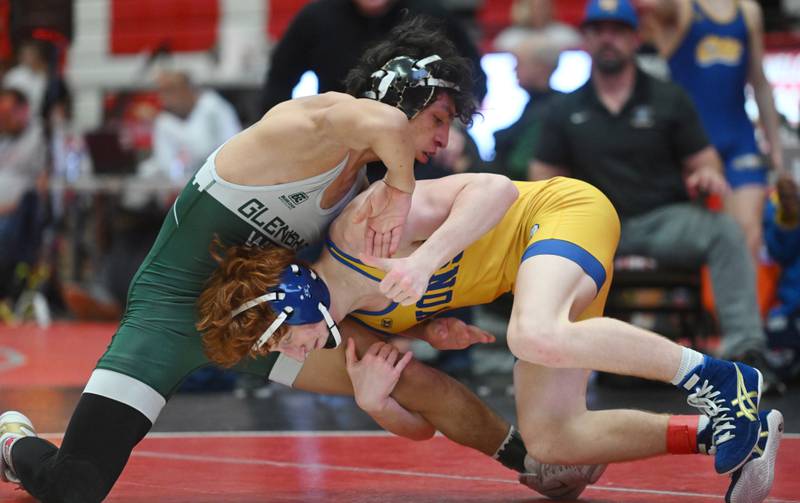 Glenbard West’s Ulises Rosas, left, competes with Lyons Township’s Griff Powell in the 132-pound final of the Hinsdale Central wrestling invitational on Saturday, Dec. 21, 2024 in Hinsdale.