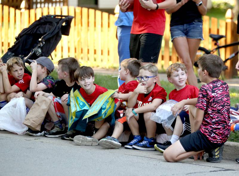 Kids wait along the curb for the Batavia High School Homecoming parade to begin on Wilson Street on Wednesday, Sept. 14, 2022.