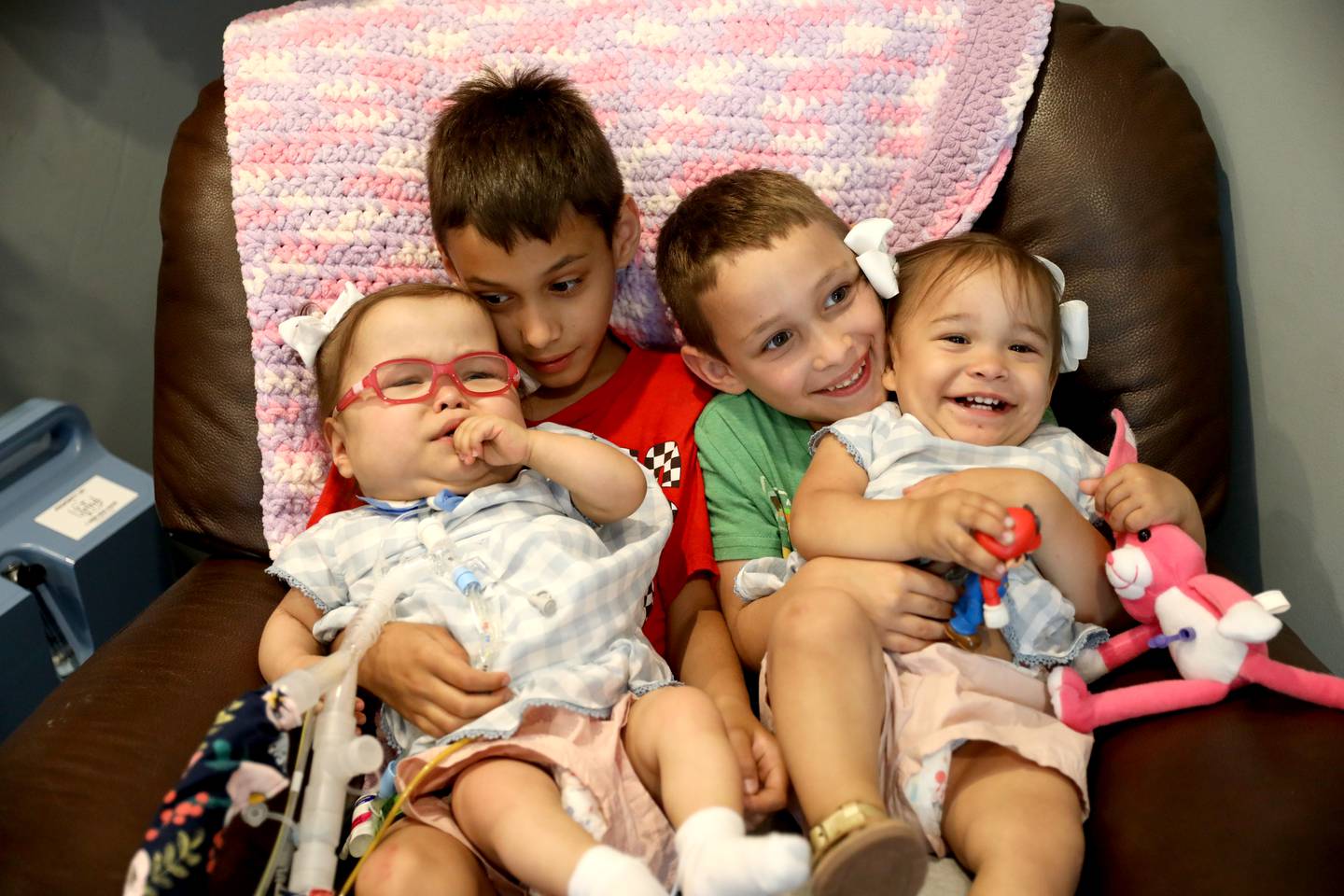 Jackson, 7, (second from left) and Easton Algrim, 6, hold their sisters, Ava (left) and Olivia in their Elburn home. Scott Algrim and Jaclyn Vasquez-Algrim welcomed twin girls Ava and Olivia prematurely in October 2020. Ava was finally able to come home on Thursday, June 2, 2022.