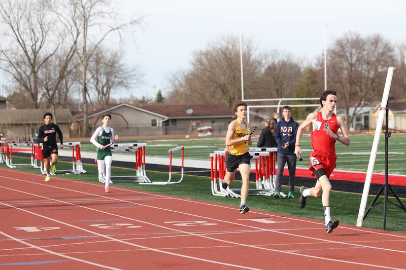 Bradley-Bourbonnais' Matthew Harris, right, Herscher's Jeremy Szepelak, Bishop McNamara's Sebastian Cortes and Momence's Calvin Mitchell run the first leg of the boys 800-meter relay during the Boilermaker Invite on Thursday, April 3, 2025.