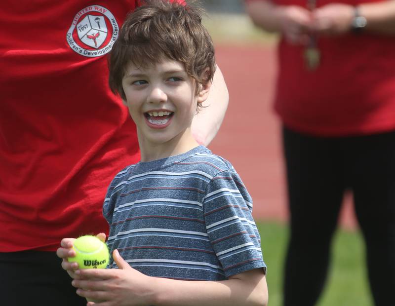 Lighted Way student Myles smiles while throwing shot put during the LighTed Way  and Trinity Catholic Academy PALS Spring Track Meet on Monday, May 13, 2024 at the L-P Athletic Complex in La Salle. LighTed way students participated in running, throwing, wheelchair slalom and much more.