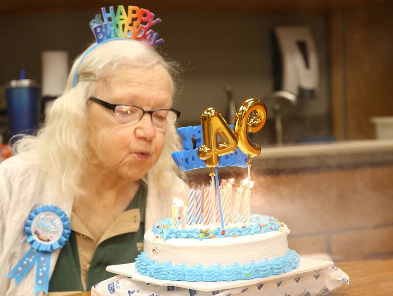 Rachel Mershon 94 of Granville, blows out the candles on her birthday cake on Monday, Sept. 22, 2025 inside the Starved Rock Visitors Center. Merschon, A former junior high teacher in Spring Valley, volunteers in the bookstore at the Starved Rock Visitors Center. Merschon drives to the Visitors Center every Monday to volunteer at the park.