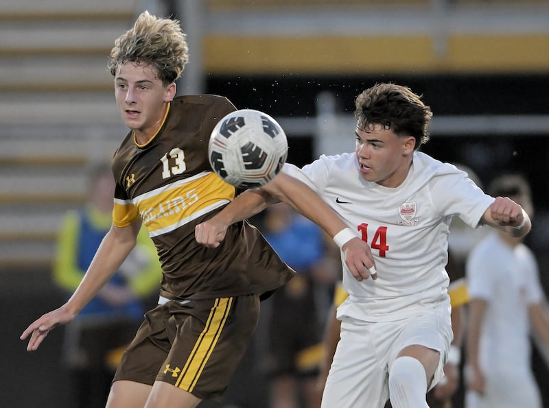 Carmel’s Nate Kovarik and Benet’s Ryan Benka fight for the ball in a boys soccer game in Mundelein on Wednesday, Sept. 17, 2025.