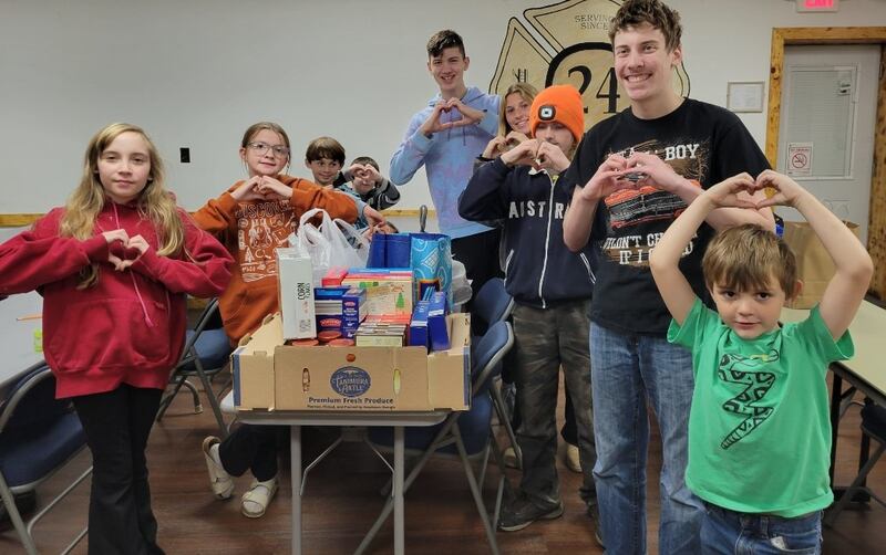 Pictured donating food are Izabel Cortinez, Hazel Friday, Luis Smith, Finn Slattery, David Wehler, Lydia Sherburne, David Bagwell, Kolton Motszko and Colton Gipper.