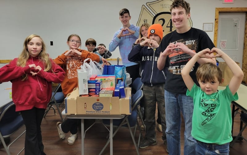 Pictured donating food are Izabel Cortinez, Hazel Friday, Luis Smith, Finn Slattery, David Wehler, Lydia Sherburne, David Bagwell, Kolton Motszko and Colton Gipper.