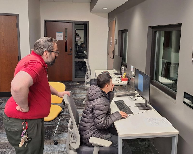 Josh Phillips leading a class from the Joliet Township High School District 204 Transition Center at the Joliet Public Library's Digital Media Studio.