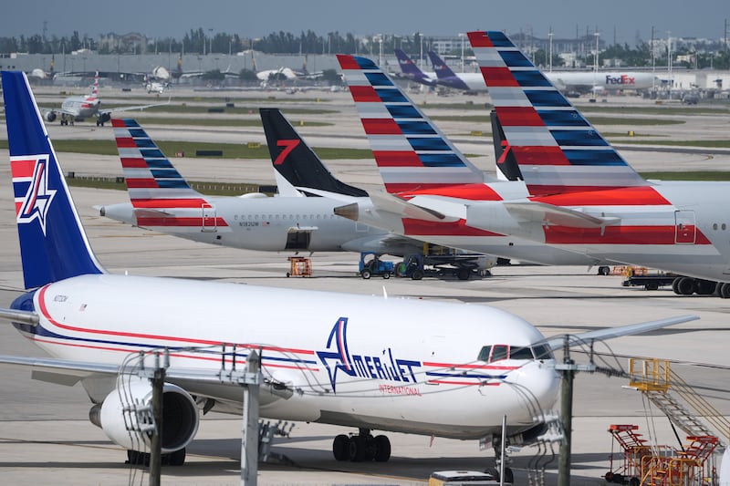 Jets sit parked on the tarmac at Miami International Airport, Monday, Nov. 10, 2025, in Miami. (AP Photo/Rebecca Blackwell)