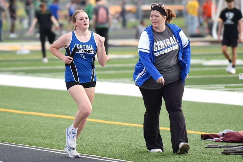 Central girls track and field coach Rebecca Swigert-Fenton, right, encourages Haley Behrends during the 4x800 m relay at the Herscher Invite Friday, May 2, 2025.