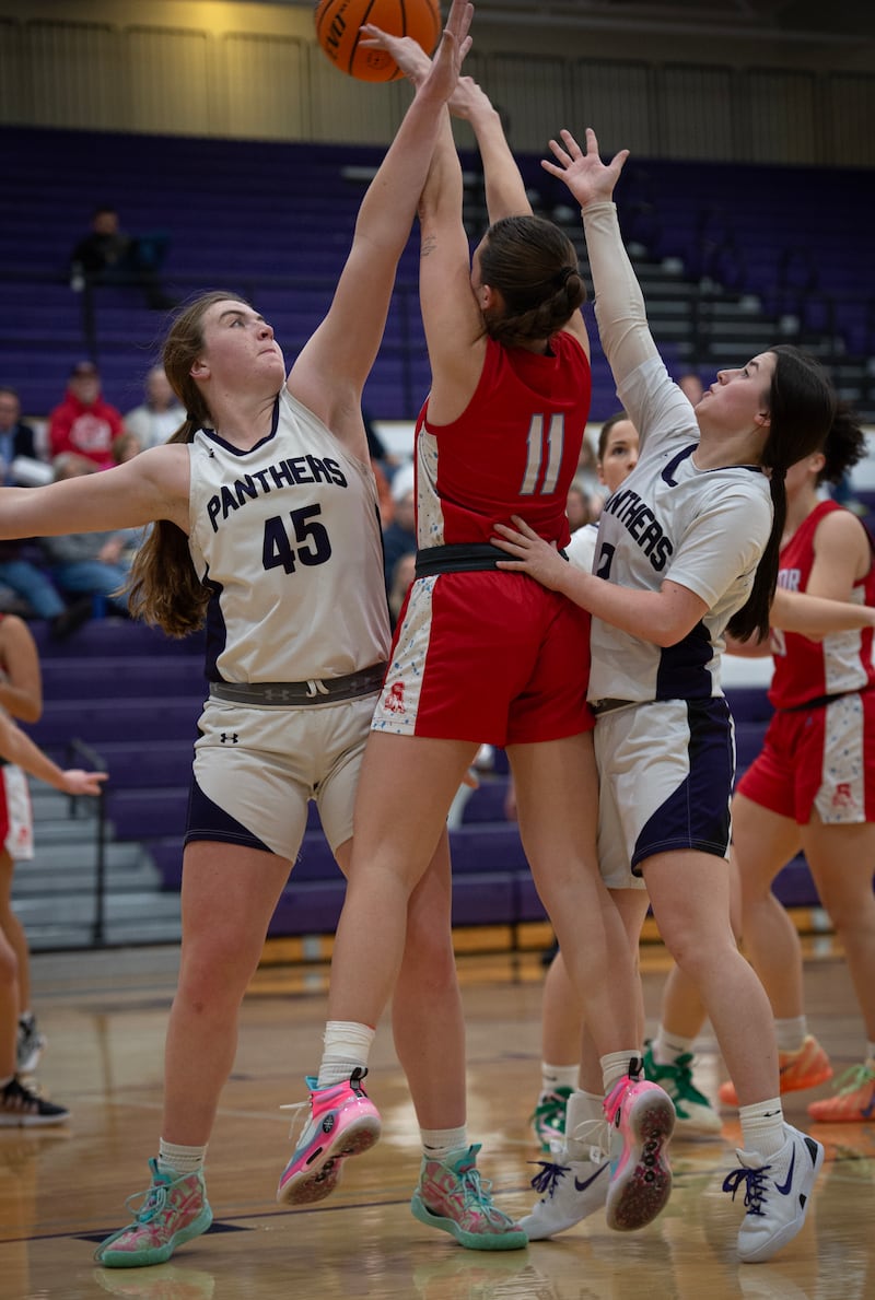 Manteno's Emily Horath, left, and Lila Prindeville, right, guard Streator's Ava Gwaltney, center, in a game on Monday, December 8, 2025.