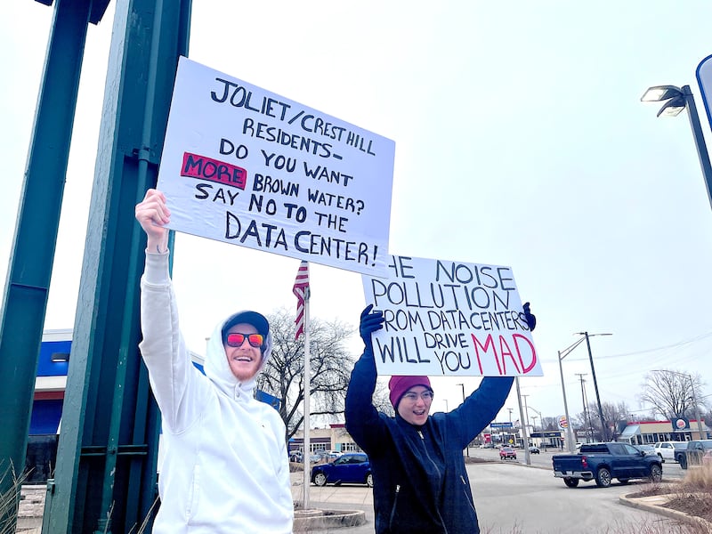 Protestors against a Joliet data center wave signs on Saturday, March 14, 2026, in Joliet.