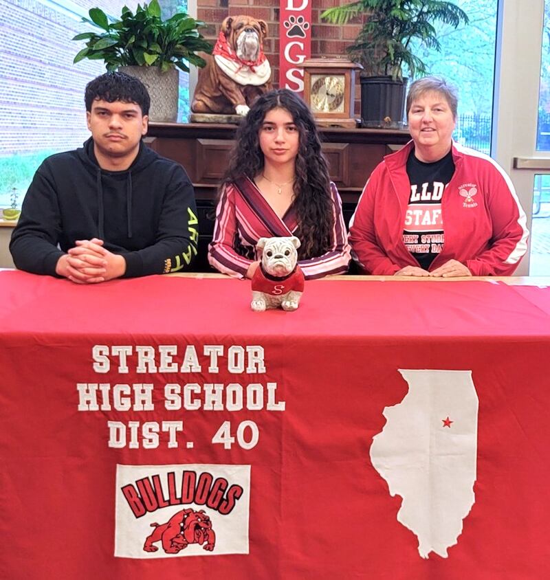 2025 Streator graduate Indyana Hernandez is continuing her education at Illinois Valley Community College in Oglesby and her tennis career at the NJCAA level with the Eagles. She is pictured here at her signing ceremony seated between her brother, Miguel Hernandez, and her Streator tennis coach, Kaye Tallier.