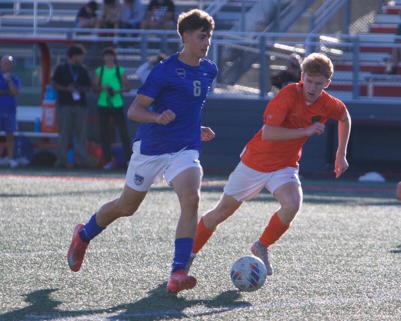 St. Charles North's Dino Valenti battles for the ball with St. Charles East's Carter Newell on Thursday, Sept. 25, 2025 in Batavia.