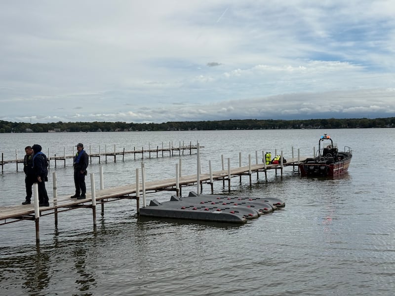Divers from the Antioch Fire Protection District and a sonar team from the Illinois Department of Natural Resources continue searching Tuesday, Oct. 7, 2025, on Fox Lake near Antioch for a man thrown from a boat he was test driving Monday night.