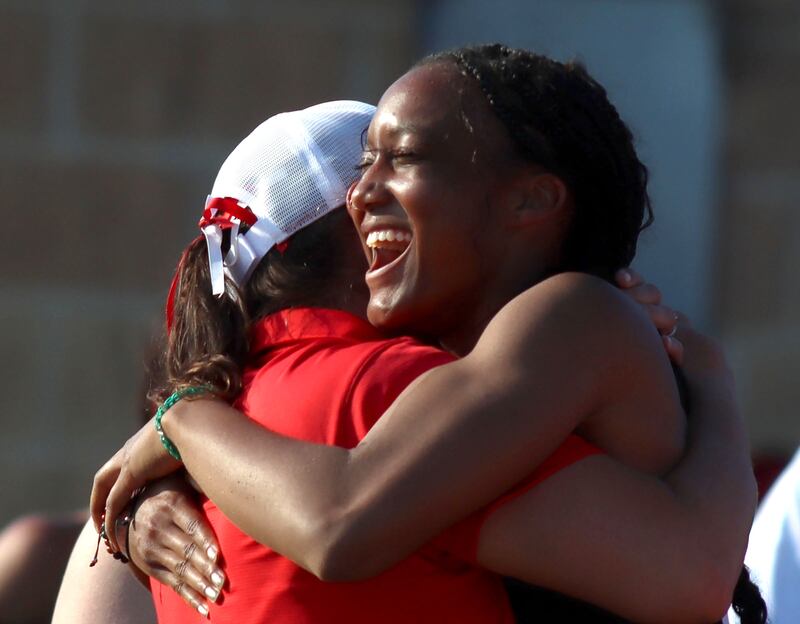 Huntley’s Dominique Johnson is greeted by coach Jennifer Garza after competing in the long  jump in IHSA Class 3A Girls Sectional Track and Field Meet action at Red Raider Stadium on the campus of Huntley High School in Huntley on Wednesday, May 14, 2025.