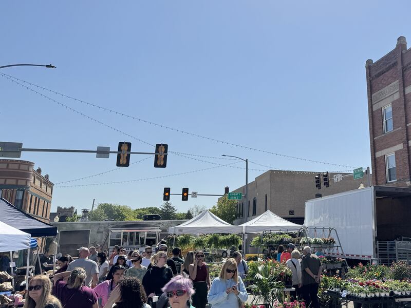 People walk down Jackson St. during the Three French Hens Country Market on Saturday, May 10, 2025.