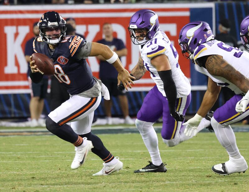 Chicago Bears quarterback Caleb Williams scrambles away from the Minnesota Vikings pass rush during their game Monday, Sept. 8, 2025, at Soldier Field in Chicago.