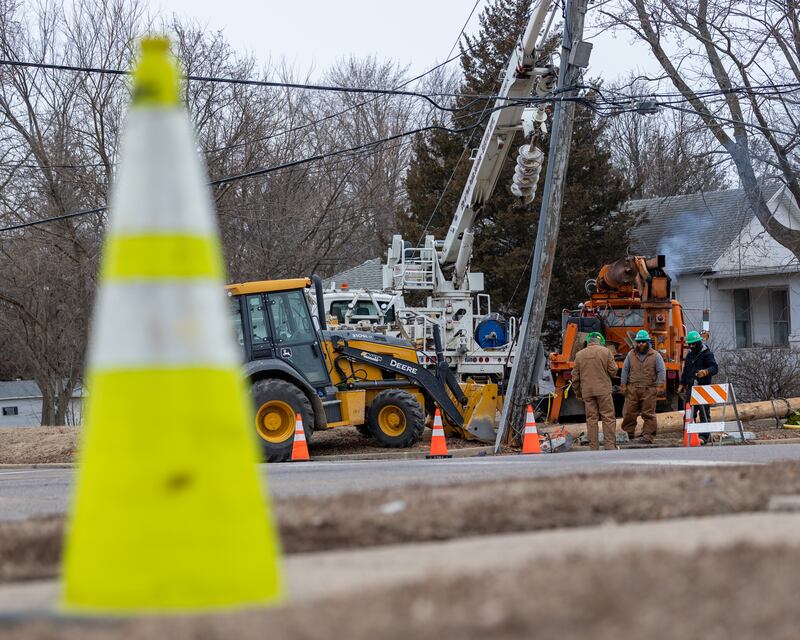 Electrical workers arrive on scene of an ejected electrical pole on Saturday, January 24, 2026, at the intersection of Shooting Park road and Pulaski street in Peru. The pole was ejected from the ground after it was struck by a semi-truck Friday afternoon. The collision has affected the electricity of multiple Peru residents.