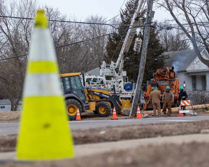 Electrical workers arrive on scene of an ejected electrical pole on Saturday, January 24, 2026, at the intersection of Shooting Park road and Pulaski street in Peru. The pole was ejected from the ground after it was struck by a semi-truck Friday afternoon. The collision has affected the electricity of multiple Peru residents.