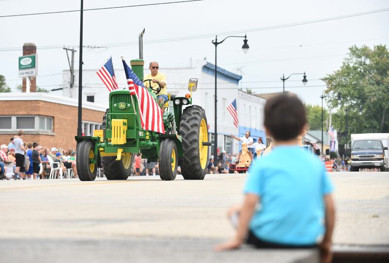 Maddox Boone, 3, of Cabery, sits to watch the tractors pass by during the 101st Herscher Labor Day parade in September 2022.