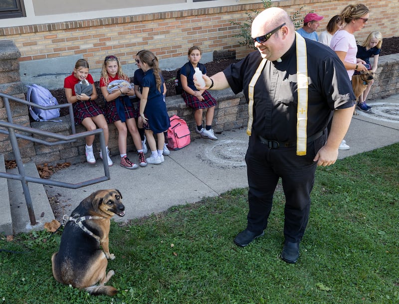 Fr. John Evans blesses a pooch Thursday, Oct. 3, 2024 at St. Mary’s School in Dixon.