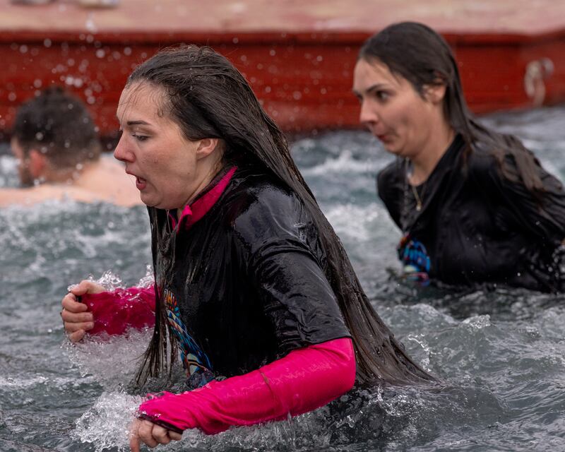 Plungers gasp for air as the cold hits them on their way out of the frigid water at the Make-A-Wish Illinois Penguin Plunge on  January 31, 2026 at Skydive Chicago.