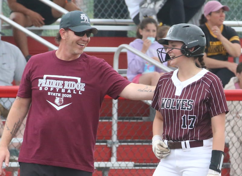 Prairie Ridge head coach Scott Busam congratulates teammate Parker Frey after hitting a triple against Burbank St. Laurence during the Class 3A State third place game on Saturday, June 14, 2025 at the Louisville Slugger Sports Complex in Peoria.
