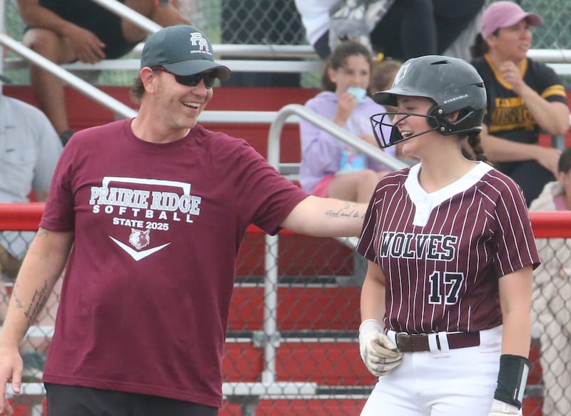 Prairie Ridge head coach Scott Busam congratulates teammate Parker Frey after hitting a triple against Burbank St. Laurence during the Class 3A State third place game on Saturday, June 14, 2025 at the Louisville Slugger Sports Complex in Peoria.