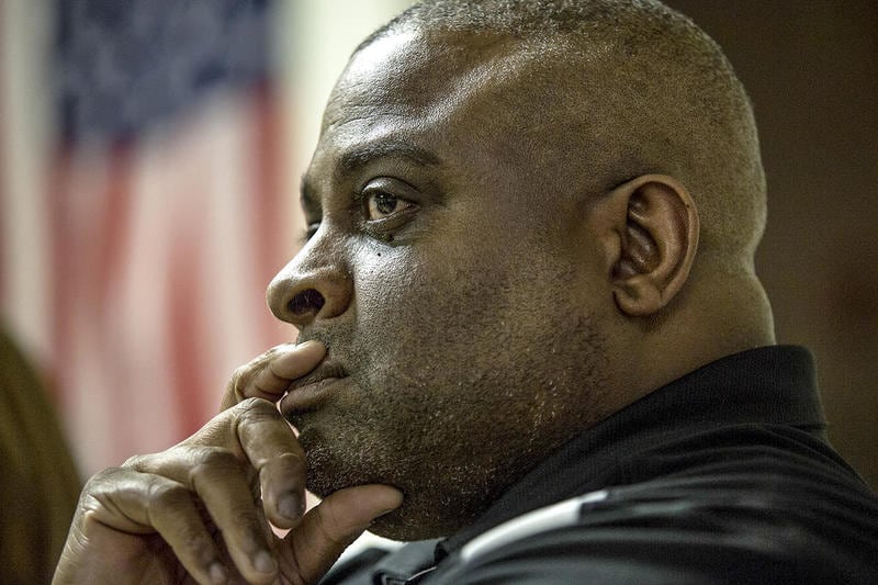 David Jackson, president of the National Black Police Association’s Joliet chapter, pauses to listen to the experiences of his fellow officers.