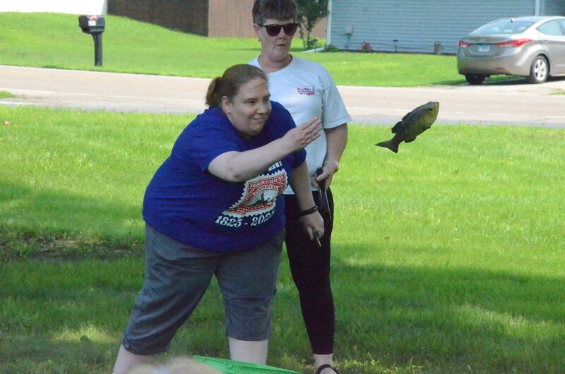 Kelly Wellin, of Wheaton, tosses a replica codfish during ancient Viking games organized by the Sons of Norway Polar Star Lodge at the St. Olaf Lutheran Church in Montgomery.