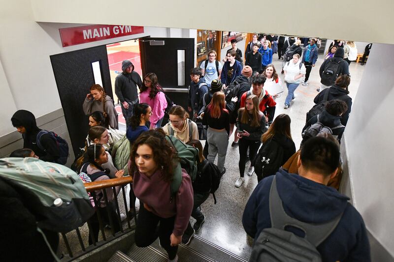 Students navigate a crowded hallway and multiple stairwells during a passing period at Bradley-Bourbonnais Community High School in March 2024.