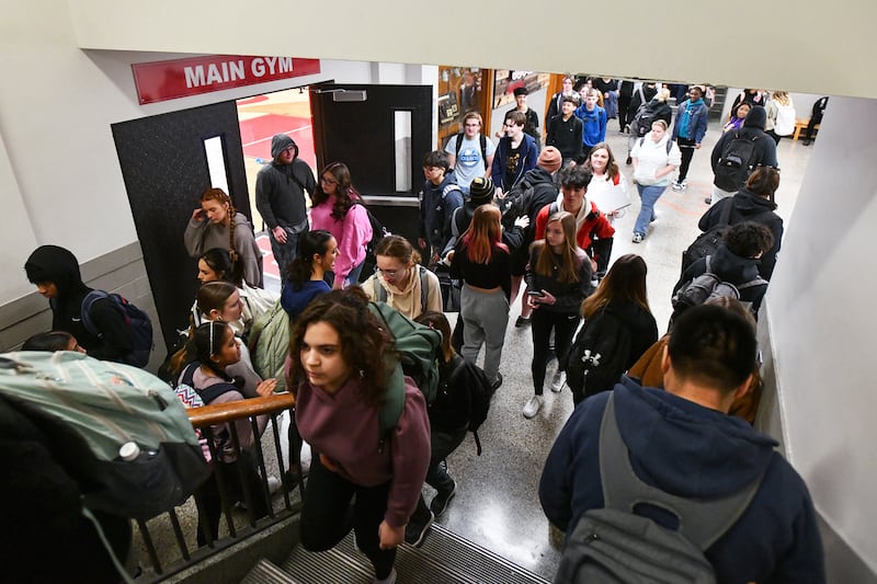 Students navigate a crowded hallway and multiple stairwells during a passing period at Bradley-Bourbonnais Community High School in March 2024.
