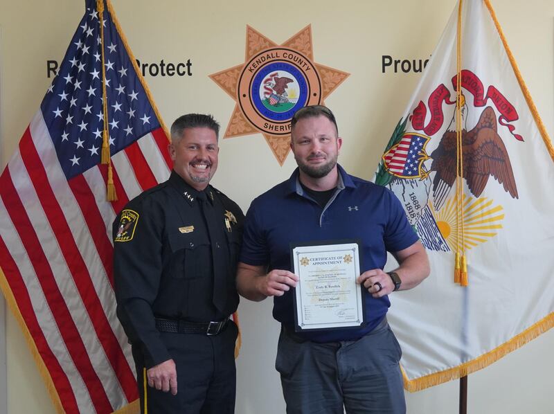 Cody Fosdick, right, was sworn in as a new patrol deputy by Kendall County Undersheriff Bobby Richardson, left.