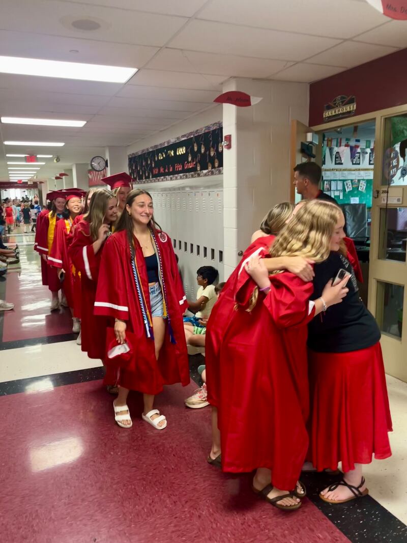 Yorkville High School seniors paraded through their old haunts, Grande Reserve Elementary School, stopping to give hugs to their former teachers.