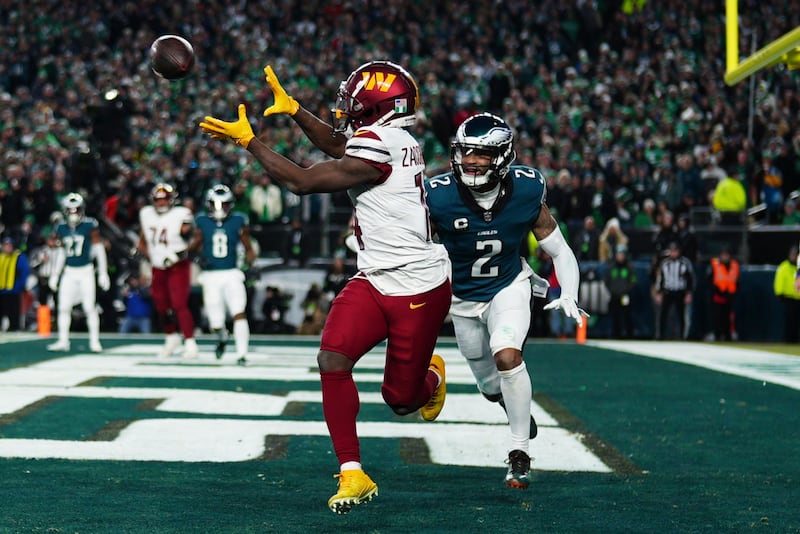 Washington Commanders wide receiver Olamide Zaccheaus (14) catches a pass for a two-point conversion as Philadelphia Eagles cornerback Darius Slay (2) defends during the second half of the NFC Championship NFL football game, Sunday, Jan. 26, 2025, in Philadelphia. (AP Photo/Derik Hamilton)