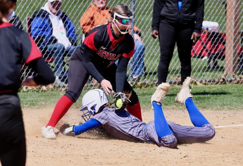 Hall third baseman Ava Delphi puts the tag on a Princeton's Caroline Keutzer in Saturday's game in Spring Valley.