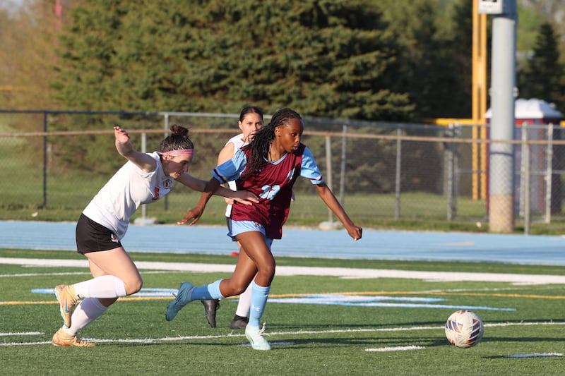 Kankakee's Alina Mkhwanazi breaks away from Beecher's Teagan Claus during Kankakee's 8-4 victory over Beecher on Wednesday, April 22, 2026.