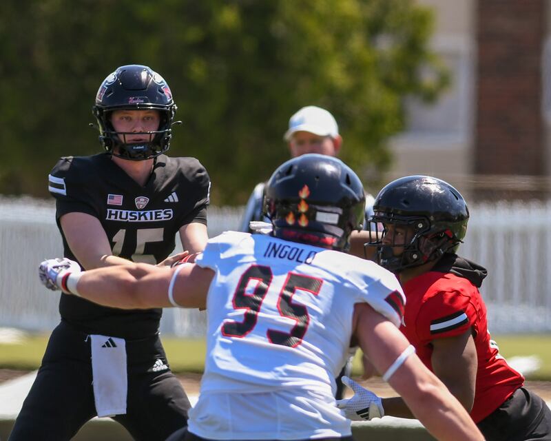 Northern Illinois University’s quarterback Josh Holst, left hands the ball off during practice on Saturday April 26, 2025, held at Huskie Stadium in DeKalb.