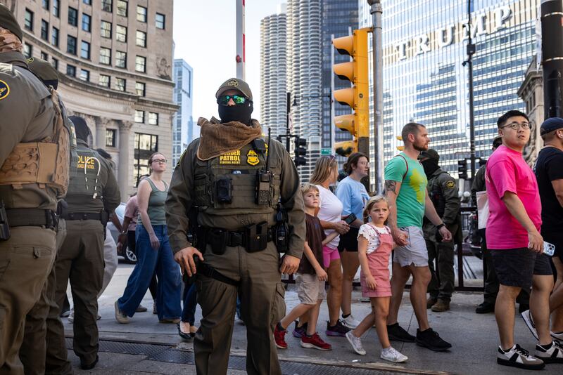 Pedestrians share the DuSable Bridge, formerly the Michigan Avenue Bridge, with federal agents from U.S. Immigration and Customs Enforcement and U.S. Customs and Border Protection as the agents walk around the Loop and River North, Sunday, Sept. 28, 2025, in Chicago. (Ashlee Rezin/Chicago Sun-Times via AP)