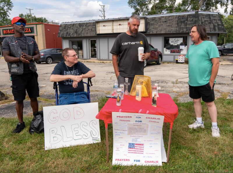 Vinyl Frontier Records owner Tim Wille, right, speaks to protesters outside of his store on Sept. 20, 2025 in McHenry.