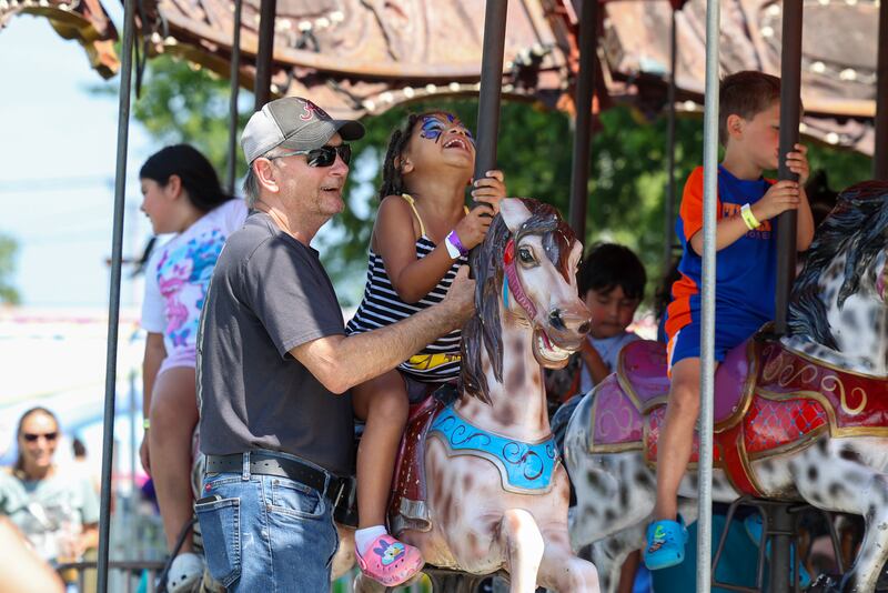Nobaleigh Ernest, 4, of Bradley, enjoys the merry-go-round with her great-grandpa, Jim Lampley, of Bourbonnais, at the Kankakee County Fair on Saturday, Aug. 2, 2025.
